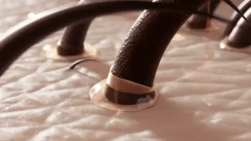 Close up of how Nue scalp massager Brush apply Oil on haris