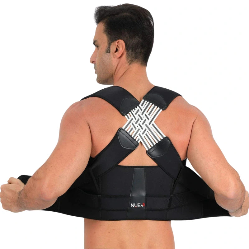 Man wearing a black posture corrector on a white background
